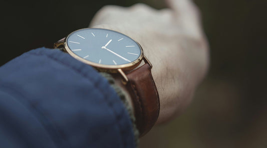 Man wearing watch with dark brown leather watch strap