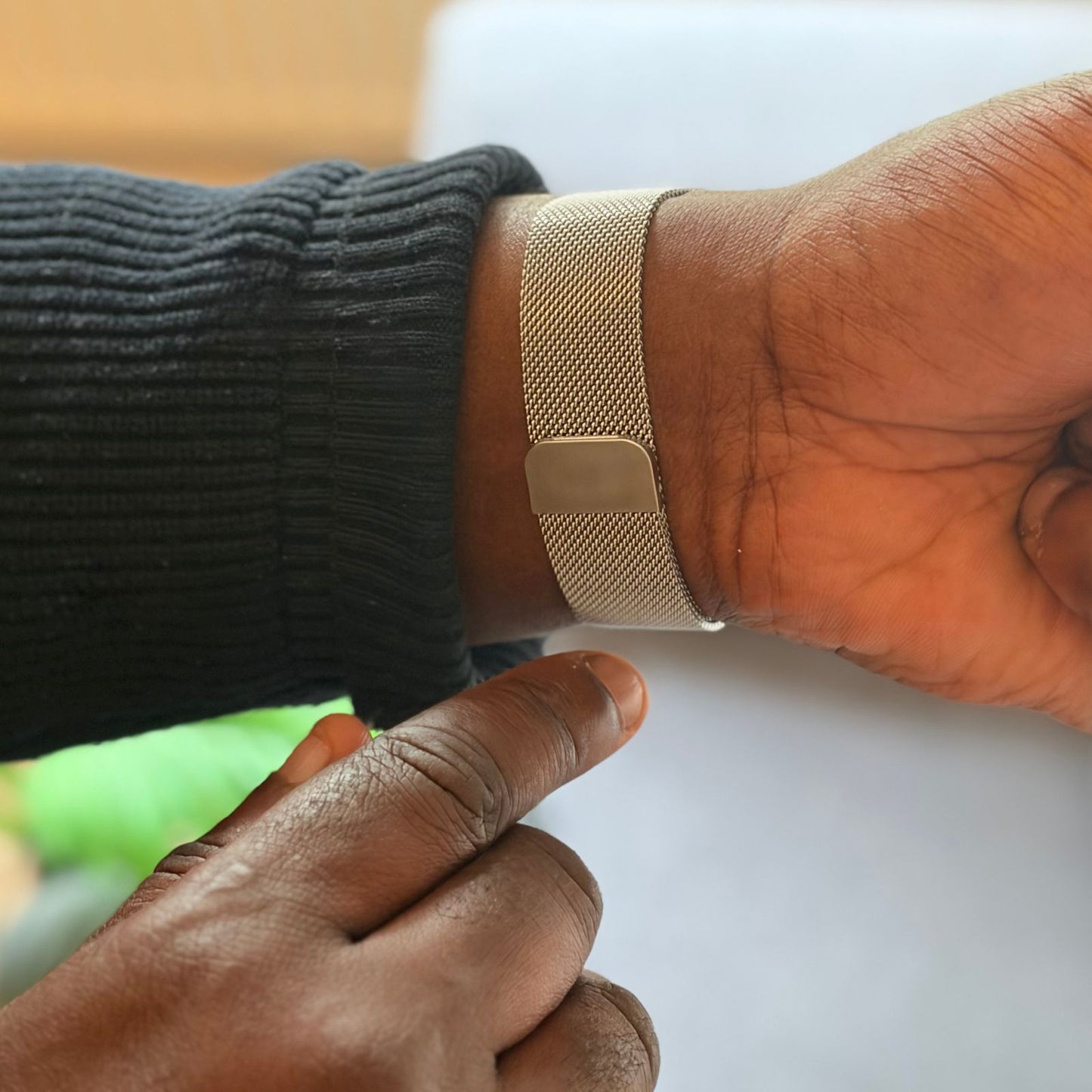 Man Showing Back Of Milanese Mesh Magnetic Strap Whilst Tucking Back Jumper Sleeve